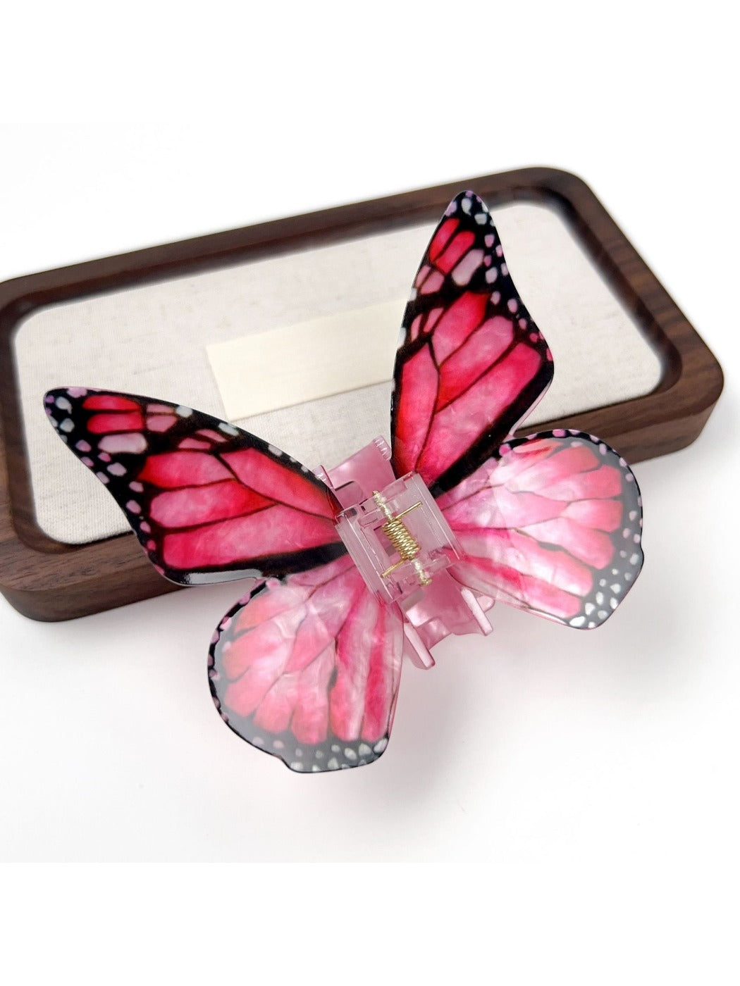 Beau butterfly hair claw clip in soft focus with blurred background