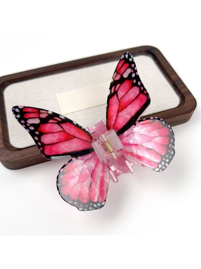 Beau butterfly hair claw clip in soft focus with blurred background