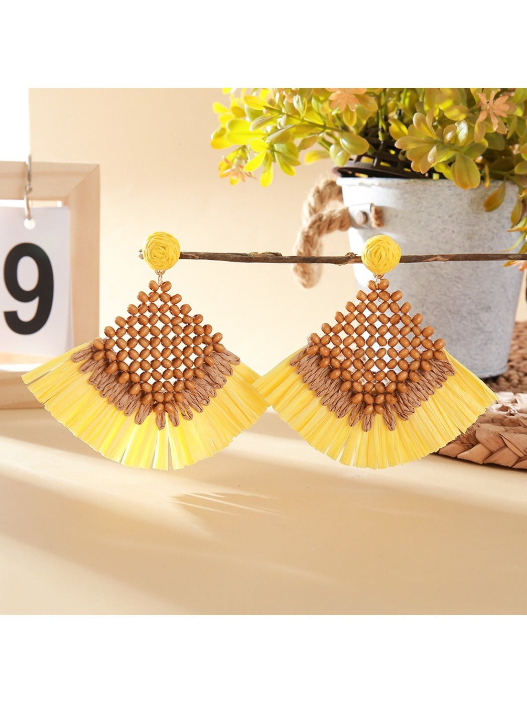 Detailed shot of woven raffia square design on vintage drop earrings with gold hooks