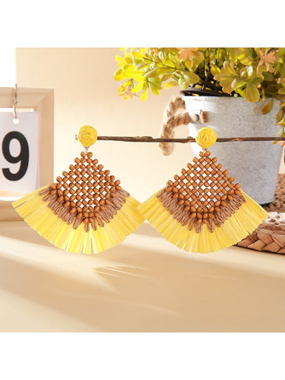 Detailed shot of woven raffia square design on vintage drop earrings with gold hooks