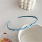 Gifty wavy headband worn by model with long hair in natural light