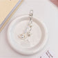 Side view of Keypus elegant keychain charm highlighting smooth pearlescent surface