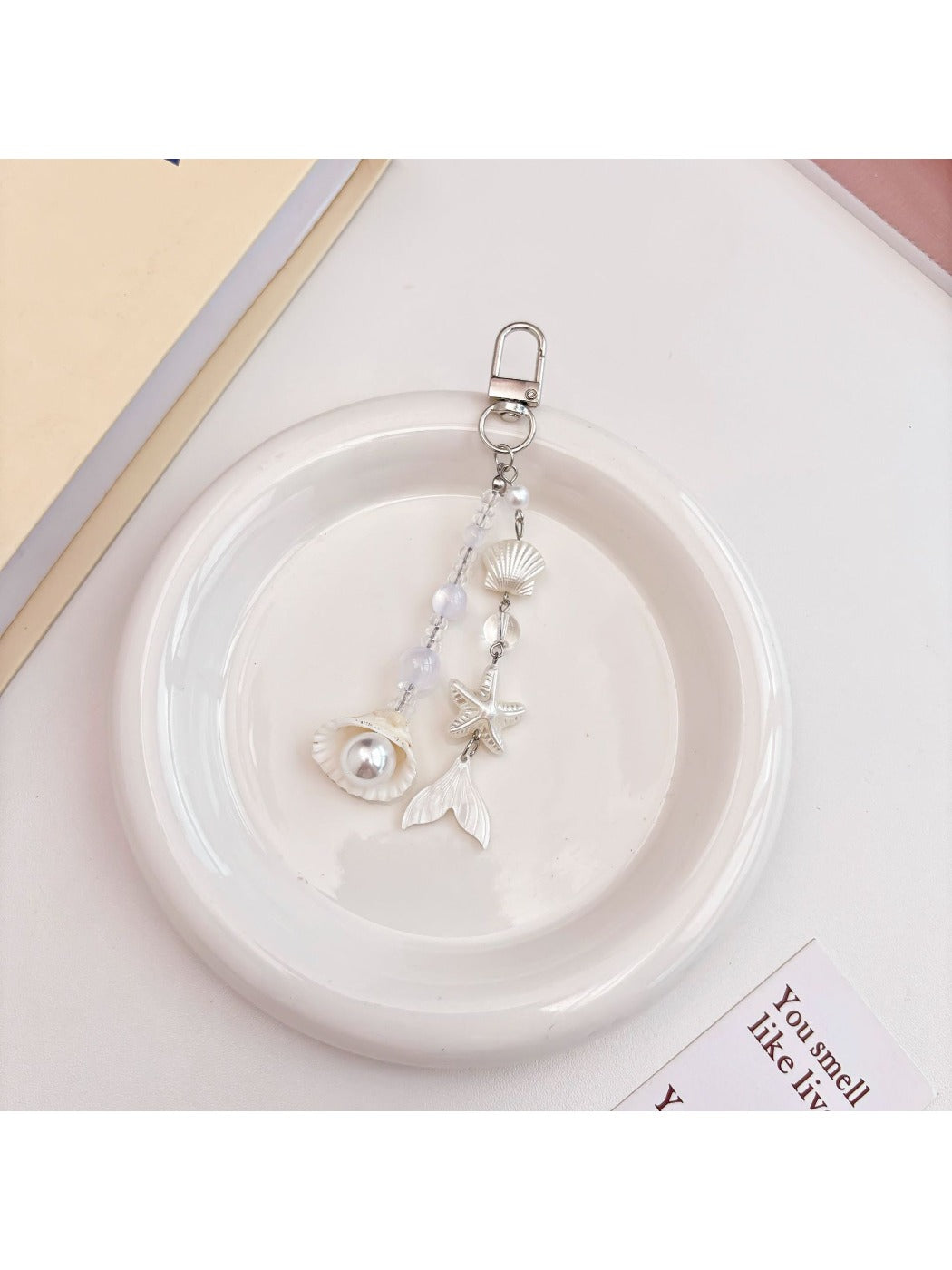 Side view of Keypus elegant keychain charm highlighting smooth pearlescent surface