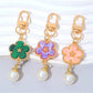 Side view of the colorful flower charm attached to a silver keyring