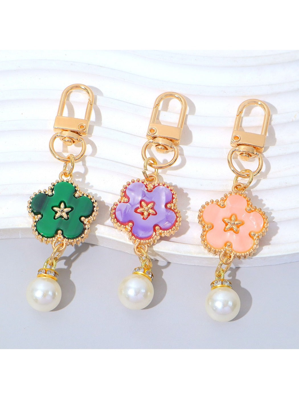 Side view of the colorful flower charm attached to a silver keyring