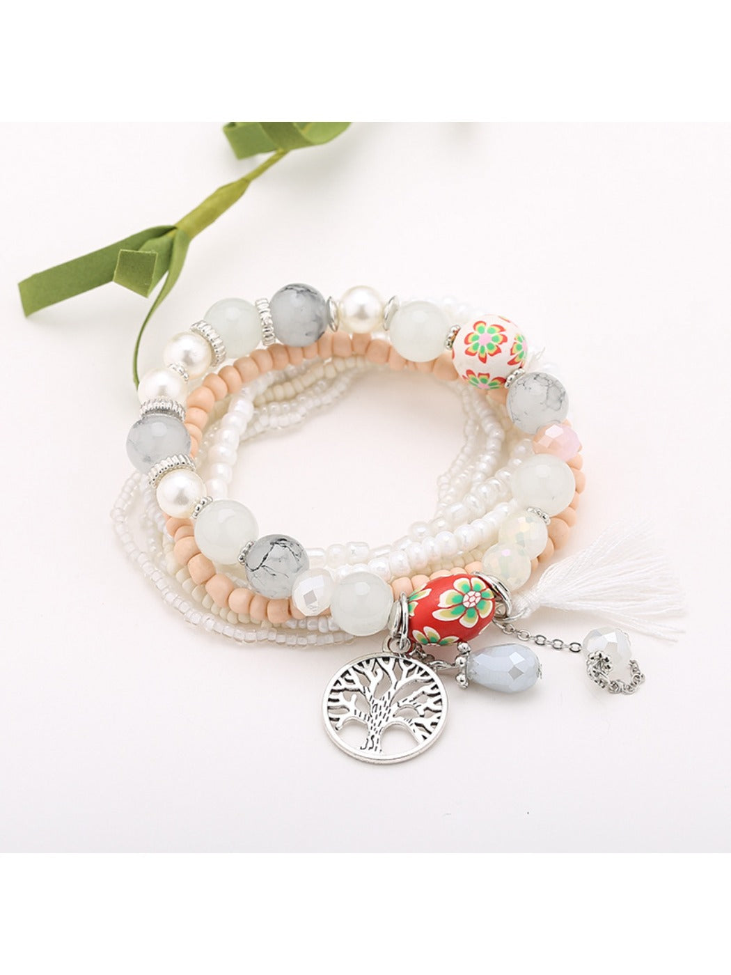 Side view of Lovra beaded bracelet highlighting tassel pendant and bead arrangement