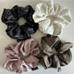 Vintage pleated fabric scrunchie displayed flat showing texture and pleats