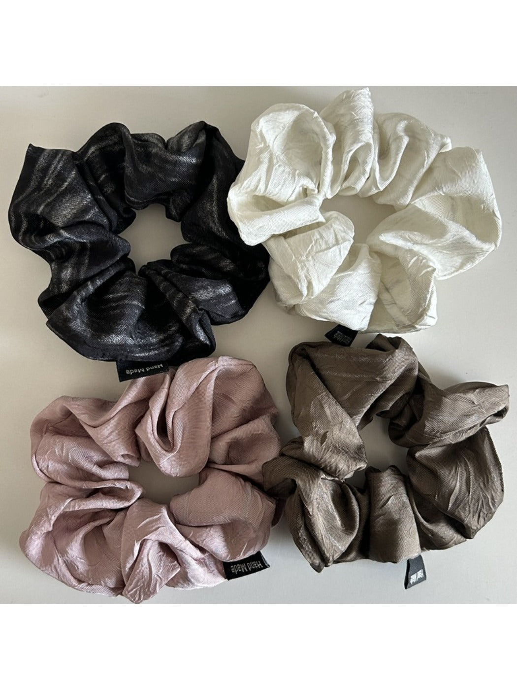 Vintage pleated fabric scrunchie displayed flat showing texture and pleats