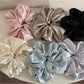 Close-up of glossy satin scrunchie fabric texture in pink