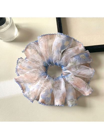 Multiple printed scrunchies stacked together showing different vintage designs
