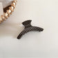 Beau polka dot acetate hair clip displayed on a flat surface with natural lighting