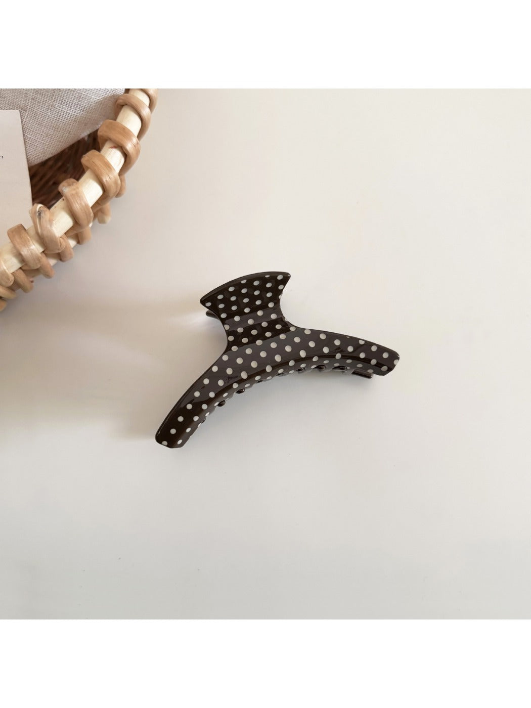 Beau polka dot acetate hair clip displayed on a flat surface with natural lighting