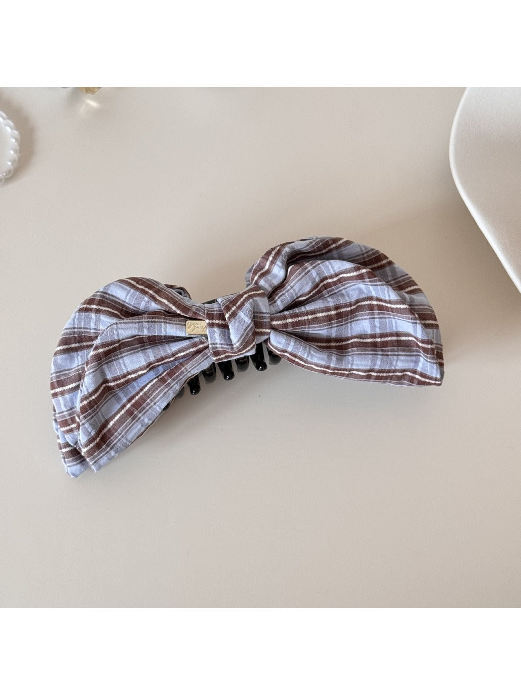 Top view of Beau elegant bow banana clip highlighting smooth bow shape