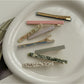 Side view of Beau acetate straight bar hair clip highlighting slim profile
