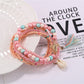Lovra bracelet with tassel charm and mixed beads arranged in a circle