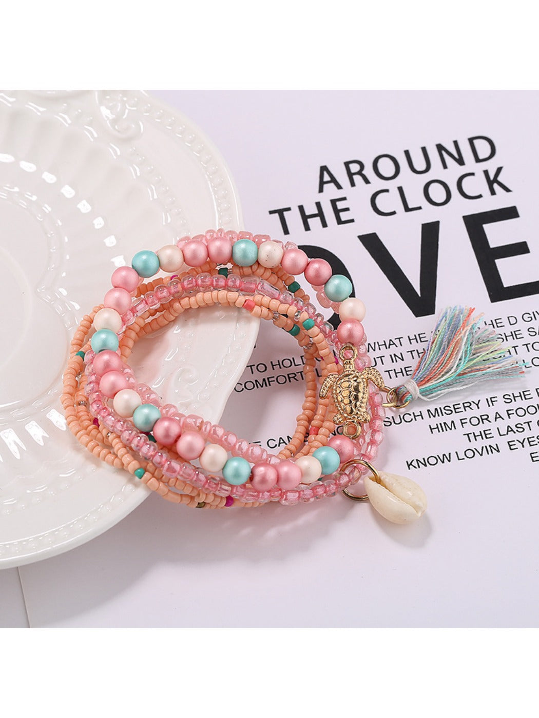 Lovra bracelet with tassel charm and mixed beads arranged in a circle