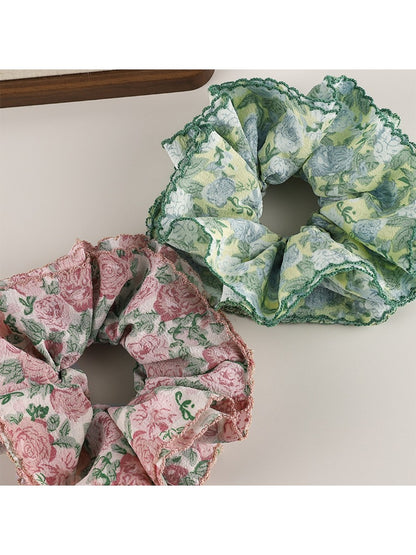 Gifty floral print scrunchie styled on a wrist with soft fabric and elastic band