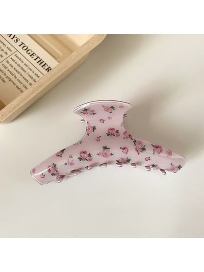 Beau hair claw clip with pink rose design photographed from above