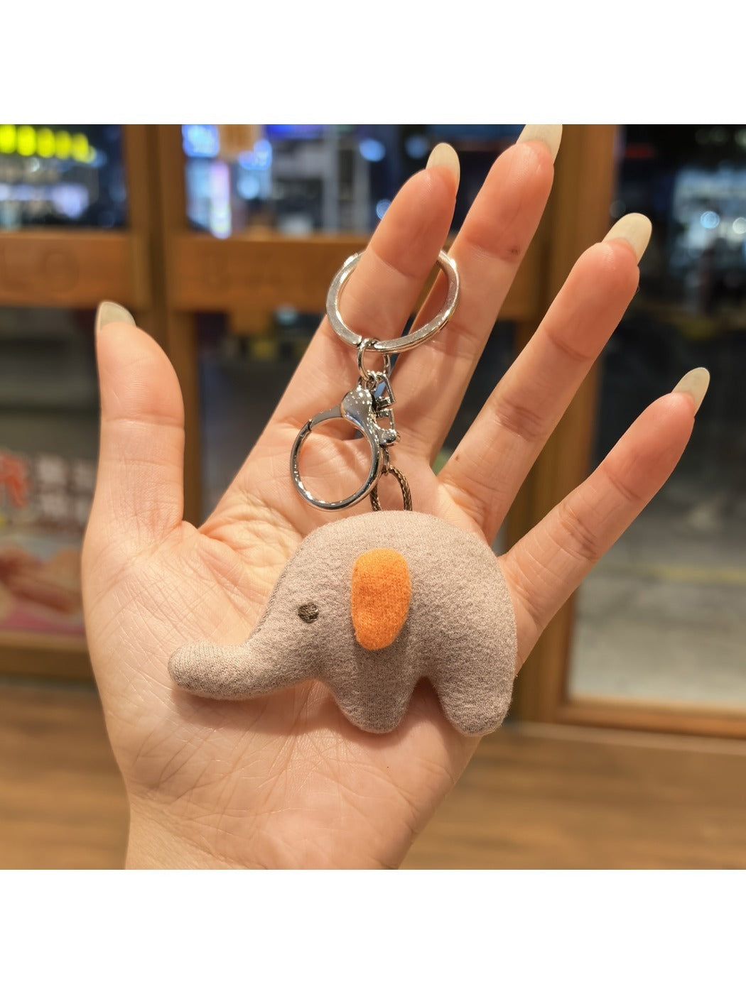 Elephant charm keychain shown with a close-up of the keyring attachment