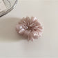 Close-up of scrunchie elastic band inside soft fabric covering