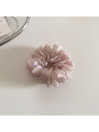 Close-up of scrunchie elastic band inside soft fabric covering