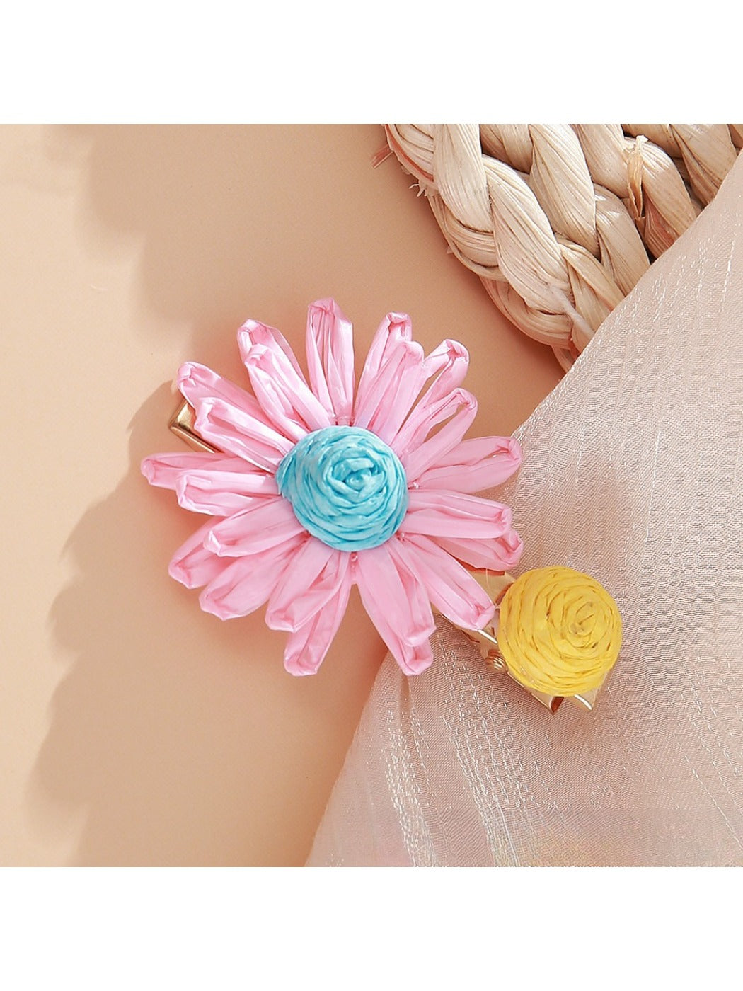 Side view of Beau raffia woven strawberry flower hair clip highlighting clip mechanism