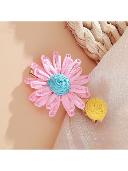 Side view of Beau raffia woven strawberry flower hair clip highlighting clip mechanism