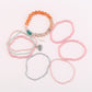Lovra stackable beaded bracelet worn on wrist with layered jewelry