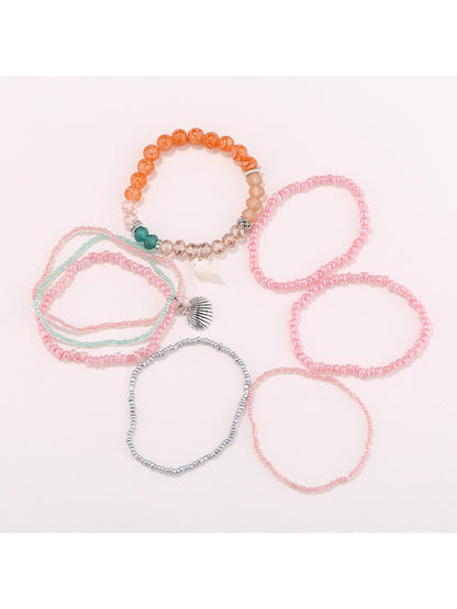 Lovra stackable beaded bracelet worn on wrist with layered jewelry
