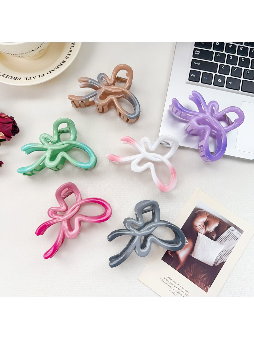 Close-up of Beau ombre heart shaped bow claw clip showing gradient colors and clasp detail