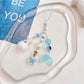 Blue glass drift bottle keychain displayed on a white background