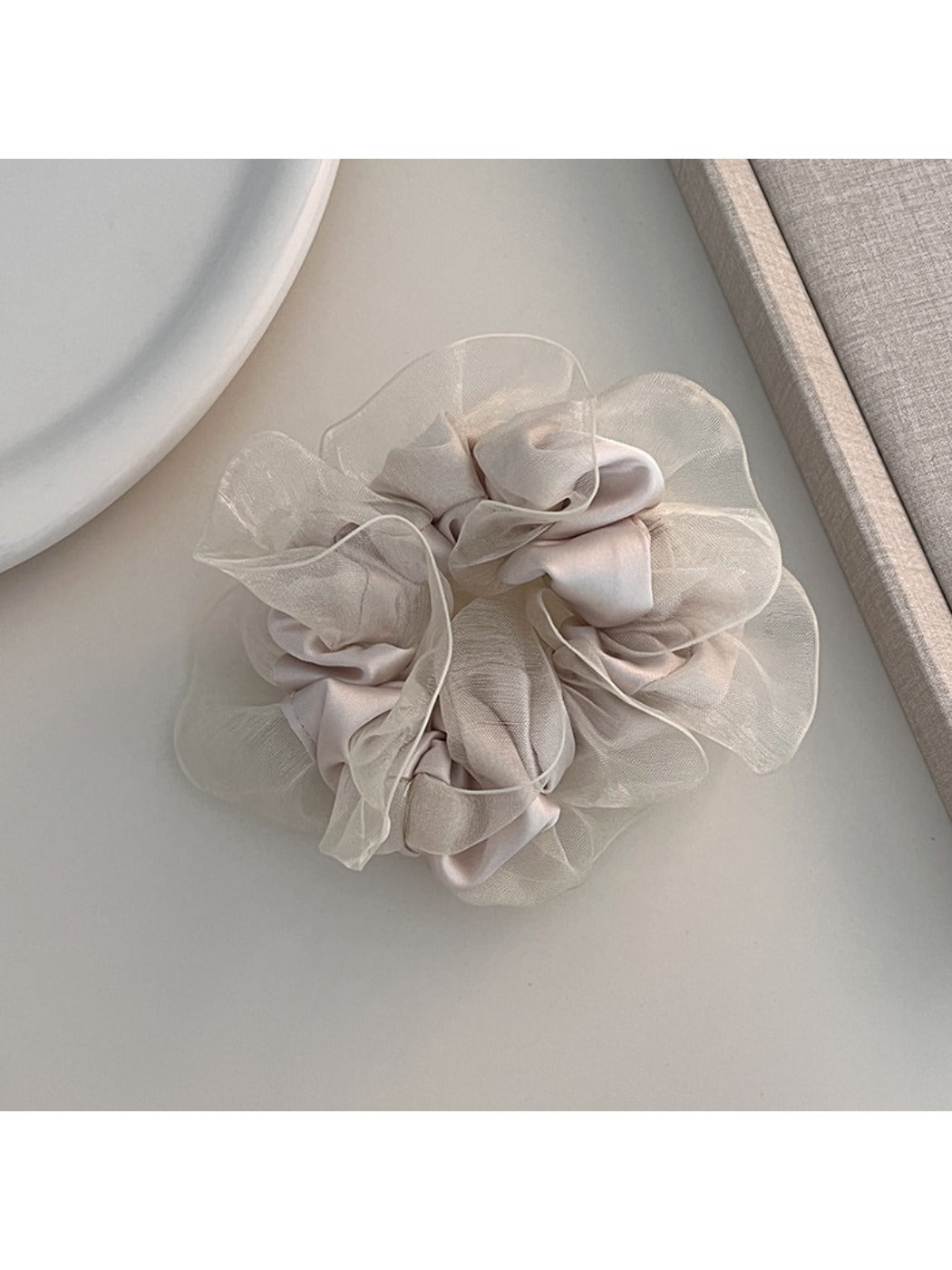 Multiple solid color ruffled scrunchies stacked together showing color variety