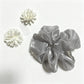 Gifty scrunchie showing detailed beadwork and layered tulle fabric in natural light