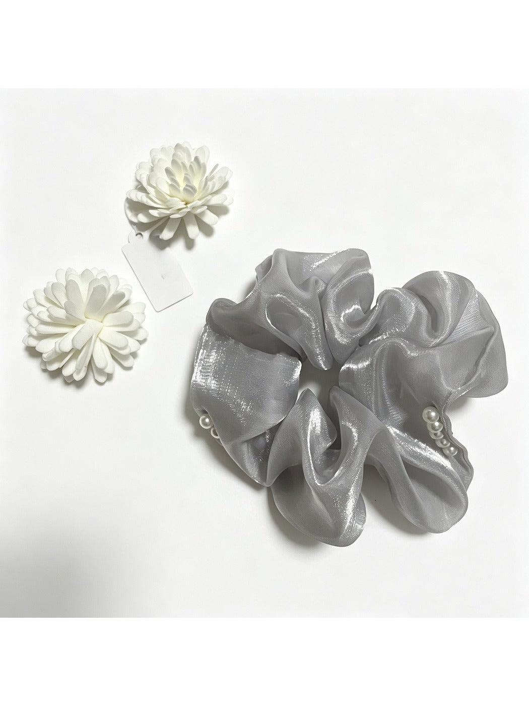 Gifty scrunchie showing detailed beadwork and layered tulle fabric in natural light