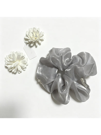 Gifty scrunchie showing detailed beadwork and layered tulle fabric in natural light