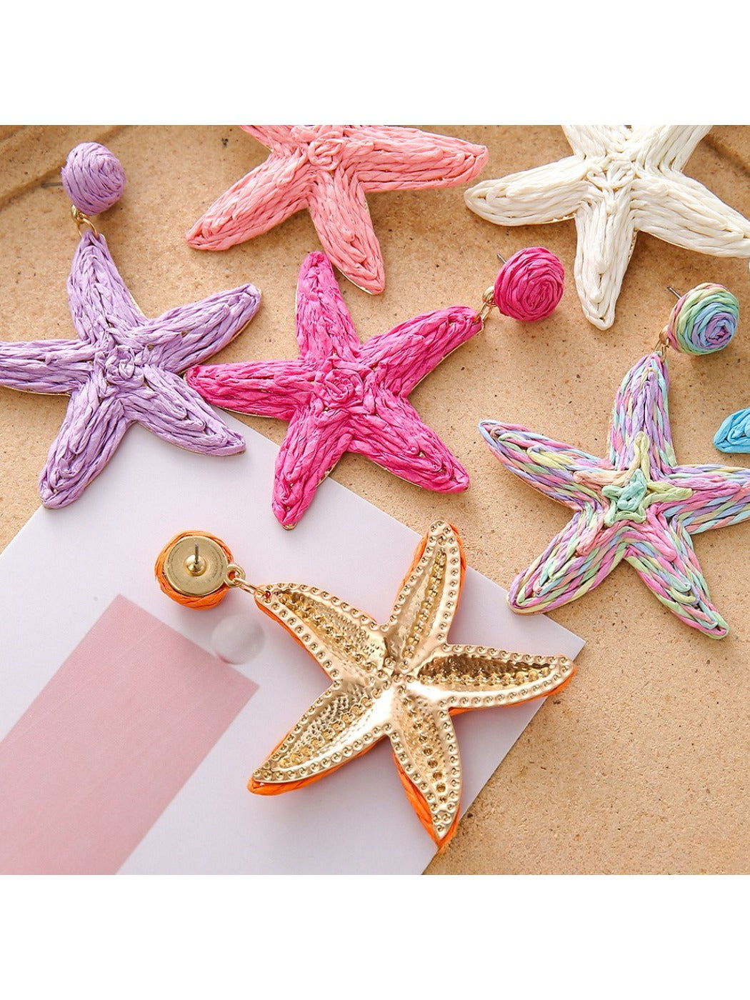 Pair of stylish starfish drop earrings displayed on a white background