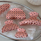 Side view of Beau pink polka dot hair clip highlighting thickness and texture