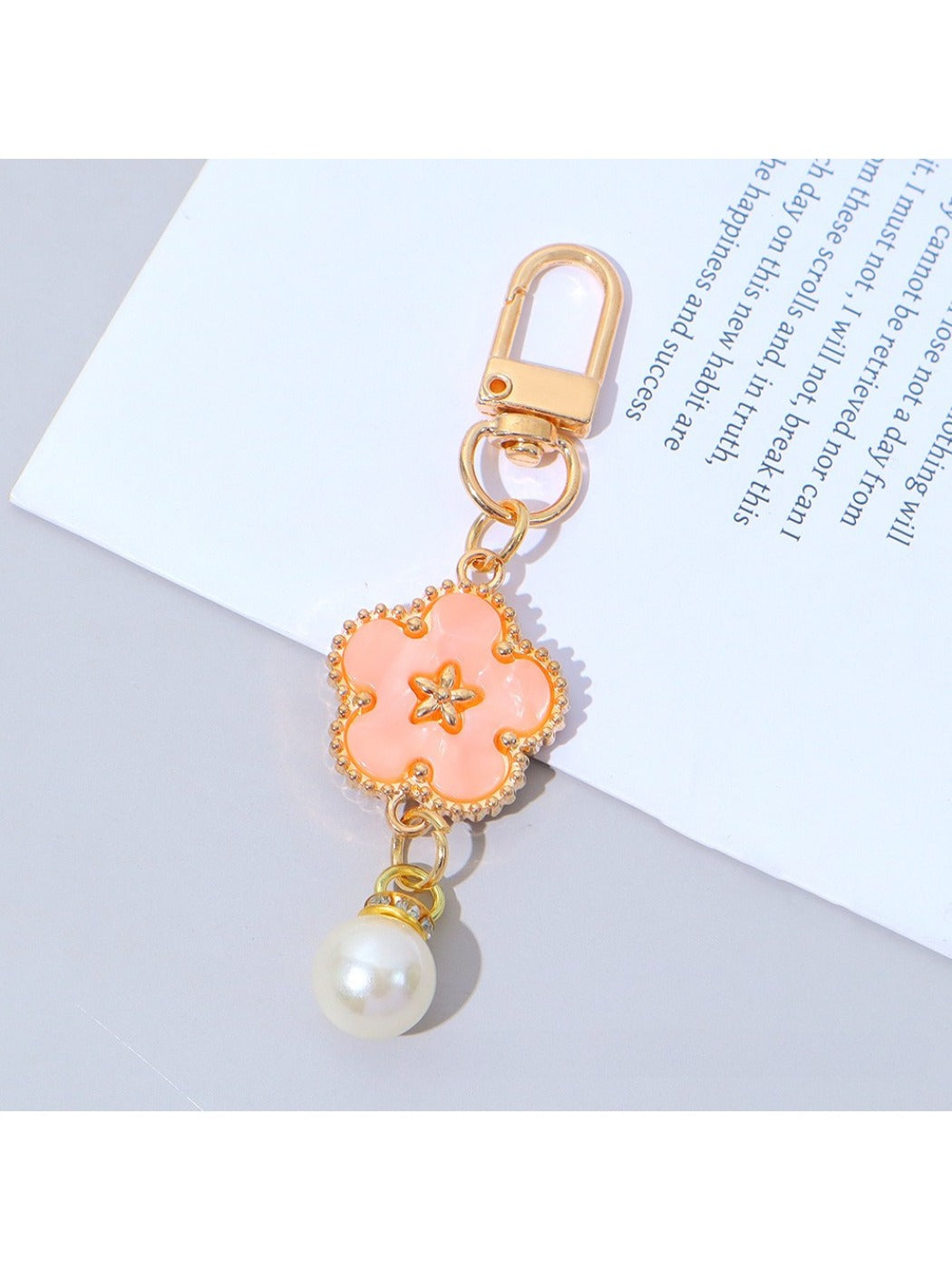 Flower charm keychain with bright multicolor petals on a white background