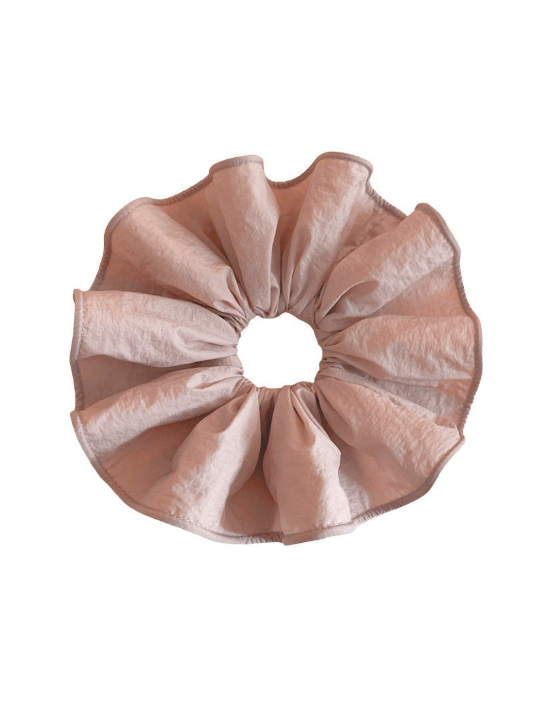 Soft pink scrunchie styled in a ponytail on a model with blonde hair