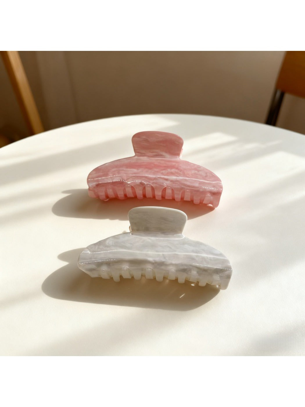 Beau candy color claw clip in pastel blue held in hand