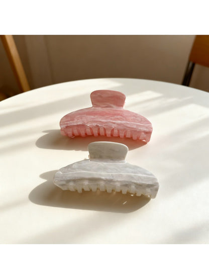 Beau candy color claw clip in pastel blue held in hand