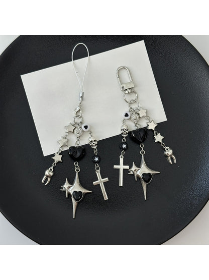 Close-up of silver cross keychain showing detailed edges and keyring attachment