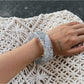 Lovra bangle bracelet styled with casual outfit on model's wrist