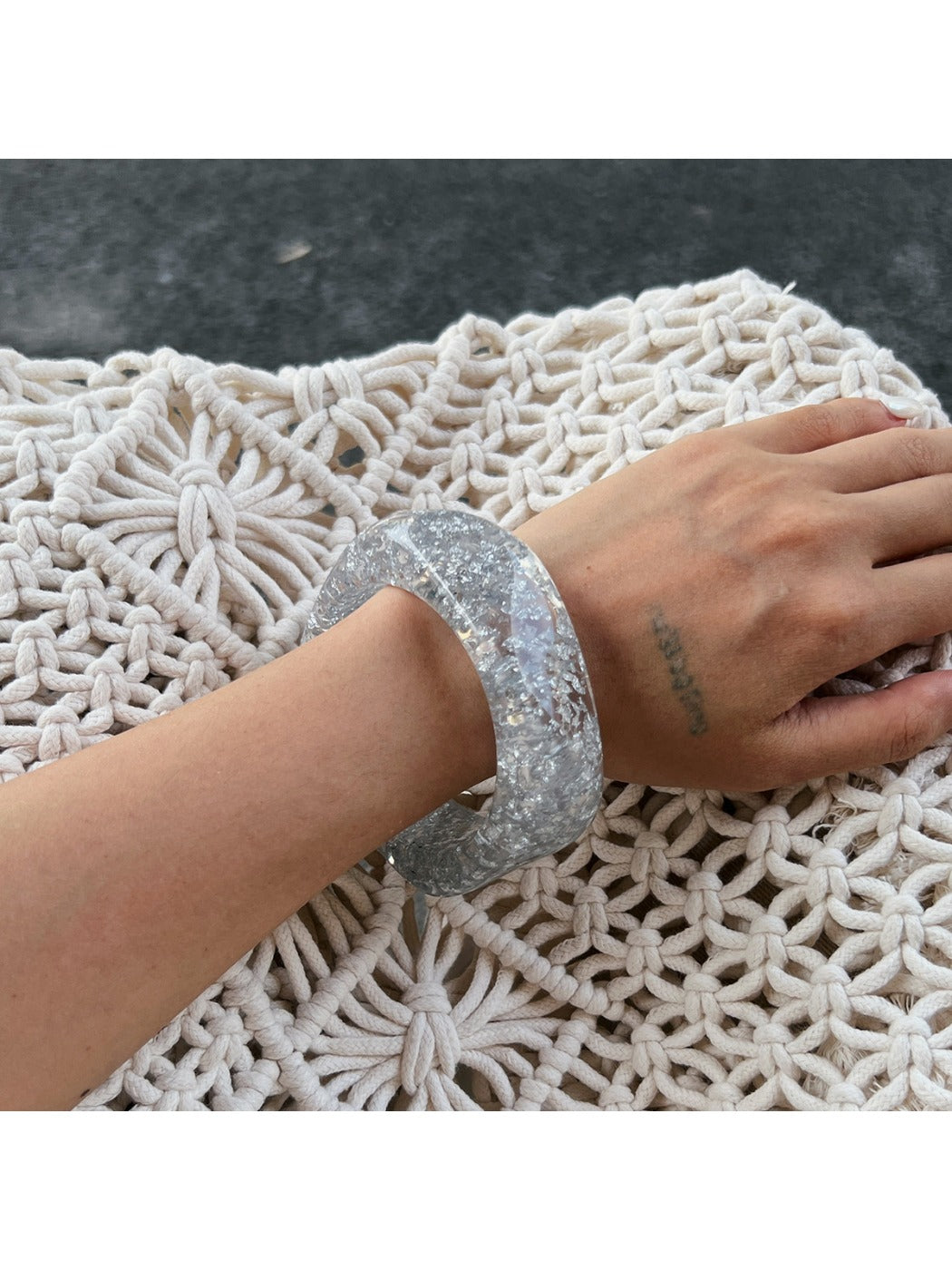 Lovra bangle bracelet styled with casual outfit on model's wrist