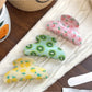 Close-up of Beau fruit print hair claw clip showing detailed design