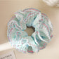 Close-up of blue ruffle scrunchie showing layered design