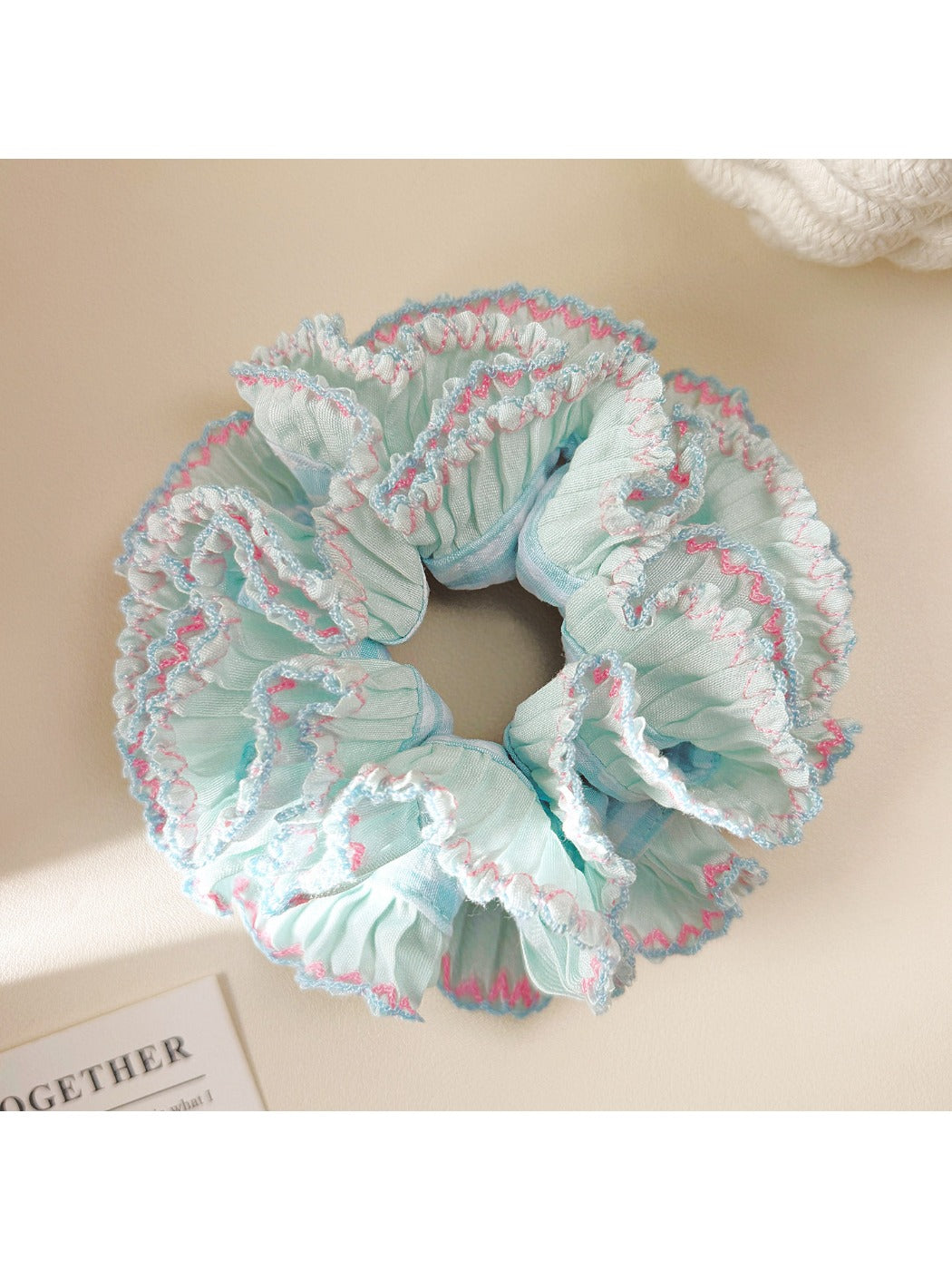 Close-up of blue ruffle scrunchie showing layered design