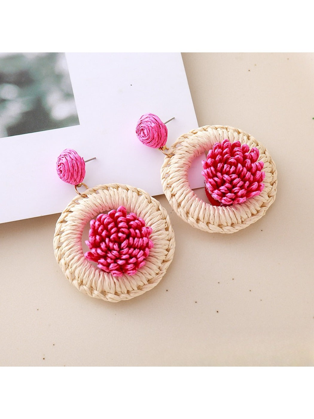 Model wearing Earedge raffia woven earrings showcasing their size and style