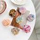 Beau sweet shell shaped hair claw clip in beige on white background
