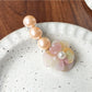Beau Camellia beaded hair clip shown clipped onto hair strands